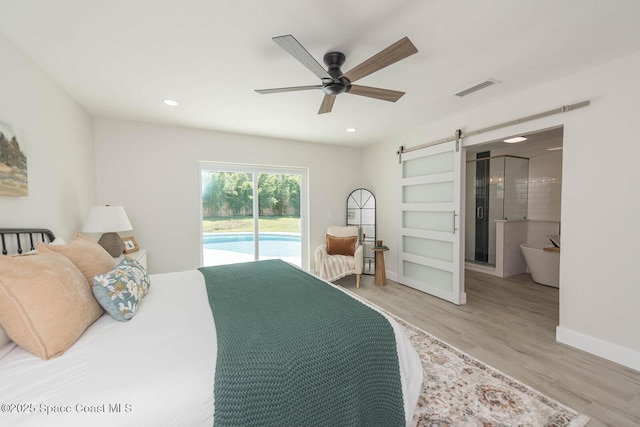3201 Nottingham Ln, Cocoa, FL 32926 - bedroom featuring a barn door, access to outside, light wood finished floors, recessed lighting, and ensuite bathroom