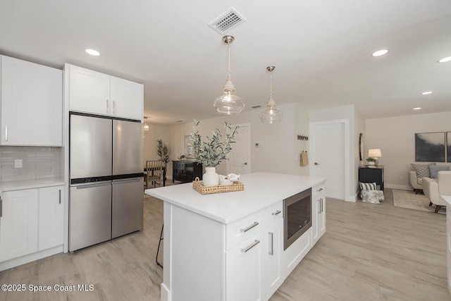 3201 Nottingham Ln, Cocoa, FL 32926 - kitchen featuring appliances with stainless steel finishes, light wood-type flooring, open floor plan, light countertops, and recessed lighting