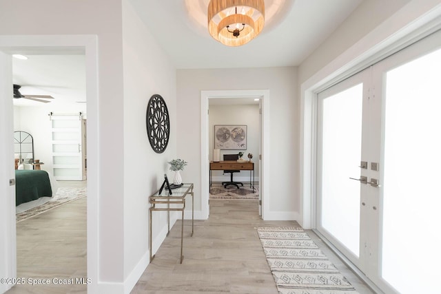 3201 Nottingham Ln, Cocoa, FL 32926 - foyer entrance featuring light wood-style floors, a barn door, and a ceiling fan