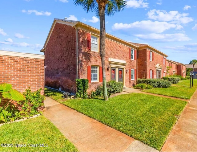 930 S Colonial Ct Unit 119, Indian Harbour Beach, FL 32937 - view of front of property with brick siding and a front lawn