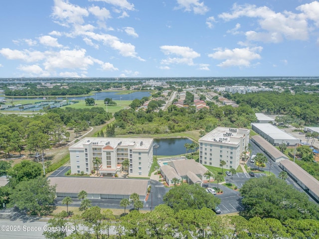 1410 Huntington Ln Unit 1204, Rockledge, FL 32955 - drone / aerial view of a nearby body of water, apartment complex / building, and a tree filled landscape