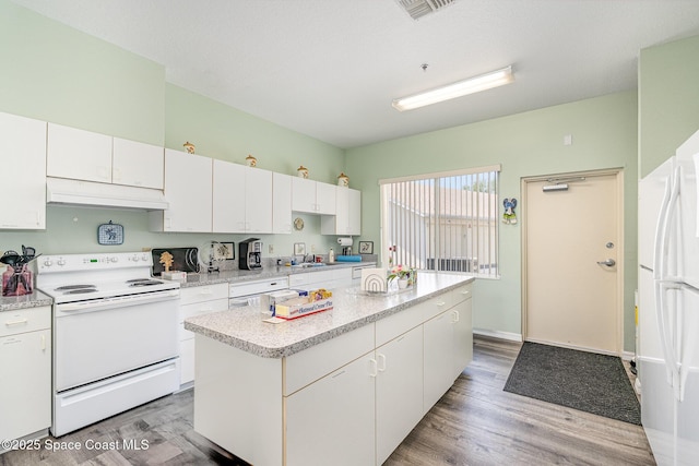 1410 Huntington Ln Unit 1204, Rockledge, FL 32955 - kitchen with white appliances, under cabinet range hood, light countertops, and white cabinets
