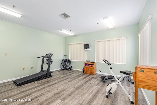 1410 Huntington Ln Unit 1204, Rockledge, FL 32955 - workout room with light wood finished floors and baseboards
