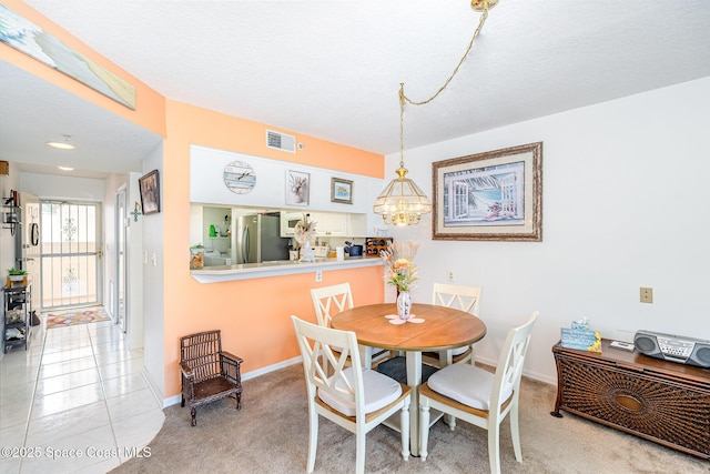 1410 Huntington Ln Unit 1204, Rockledge, FL 32955 - dining room featuring a chandelier, carpet flooring, baseboards, and a textured ceiling