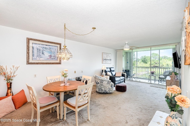 1410 Huntington Ln Unit 1204, Rockledge, FL 32955 - carpeted dining area with expansive windows, a textured ceiling, and a ceiling fan