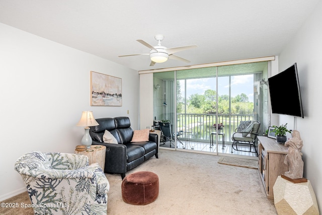 1410 Huntington Ln Unit 1204, Rockledge, FL 32955 - living room featuring a wall of windows, carpet floors, and ceiling fan