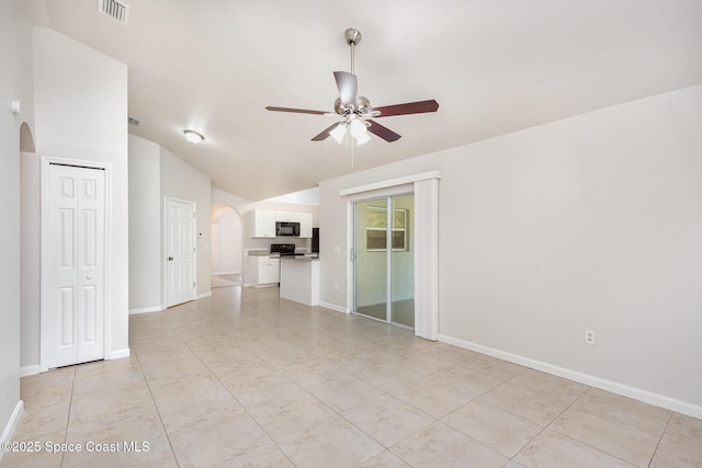 1094 Locust Ave NW, Palm Bay, FL 32907 - empty room featuring arched walkways, vaulted ceiling, ceiling fan, and baseboards
