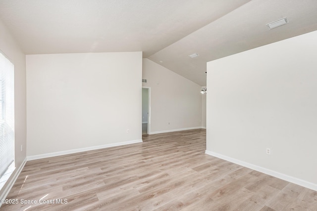 1094 Locust Ave NW, Palm Bay, FL 32907 - empty room with light wood-style flooring, vaulted ceiling, and baseboards