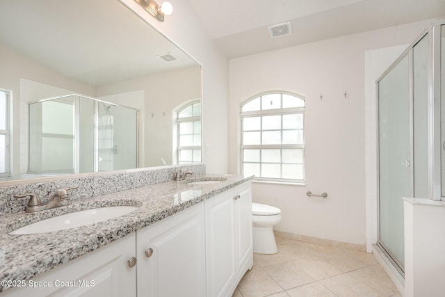 1094 Locust Ave NW, Palm Bay, FL 32907 - bathroom featuring toilet, a shower stall, double vanity, tile patterned flooring, and baseboards