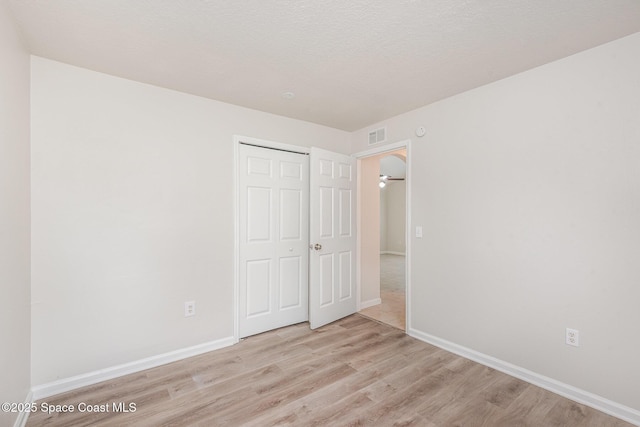 1094 Locust Ave NW, Palm Bay, FL 32907 - unfurnished bedroom with wood finished floors, a closet, and baseboards