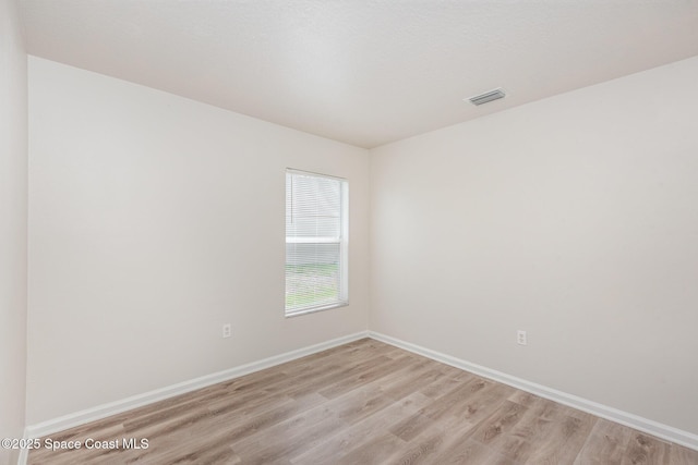 1094 Locust Ave NW, Palm Bay, FL 32907 - unfurnished room featuring light wood finished floors and baseboards