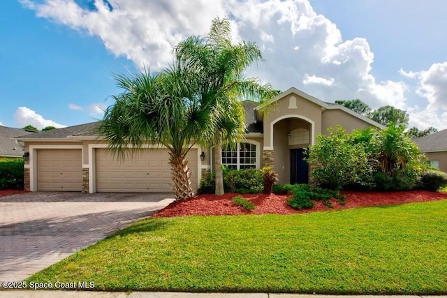 294 Brandy Creek Cir SE, Palm Bay, FL 32909 - view of front of house featuring stucco siding, an attached garage, driveway, and a front lawn