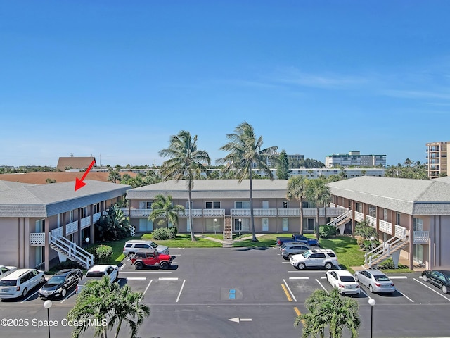 3150 N Atlantic Ave Unit 4-990, Cocoa Beach, FL 32931 - uncovered parking lot featuring stairs