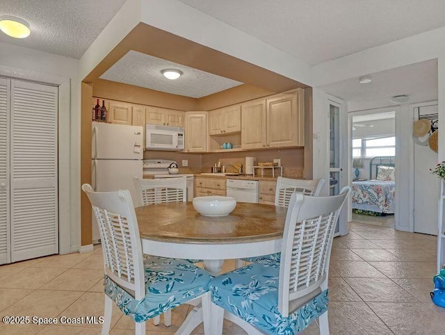 3150 N Atlantic Ave Unit 4-990, Cocoa Beach, FL 32931 - dining room with a textured ceiling, light tile patterned floors, and baseboards