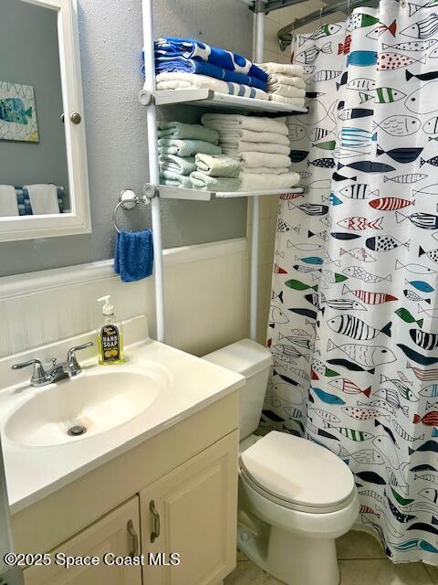 3150 N Atlantic Ave Unit 4-990, Cocoa Beach, FL 32931 - full bathroom with vanity, tile patterned flooring, toilet, curtained shower, and a textured wall