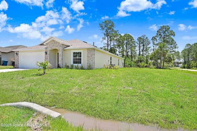 2597 Galiano Ave, Palm Bay, FL 32908 - view of front of home with stone siding, an attached garage, concrete driveway, a front lawn, and stucco siding