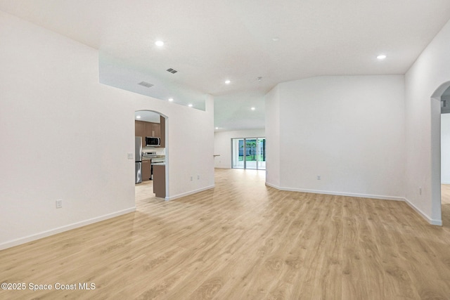 2597 Galiano Ave, Palm Bay, FL 32908 - unfurnished living room with arched walkways, light wood finished floors, recessed lighting, and baseboards