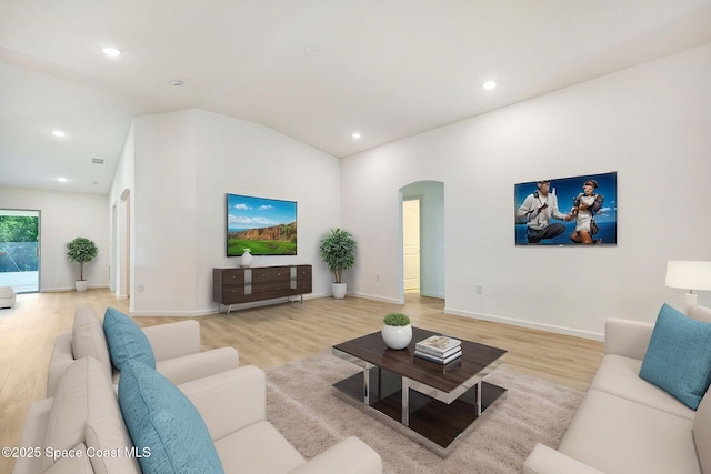 2597 Galiano Ave, Palm Bay, FL 32908 - living area with arched walkways, light wood finished floors, recessed lighting, and baseboards