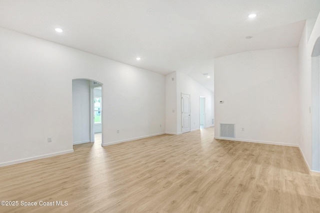 2597 Galiano Ave, Palm Bay, FL 32908 - empty room with arched walkways, light wood-style floors, recessed lighting, and baseboards