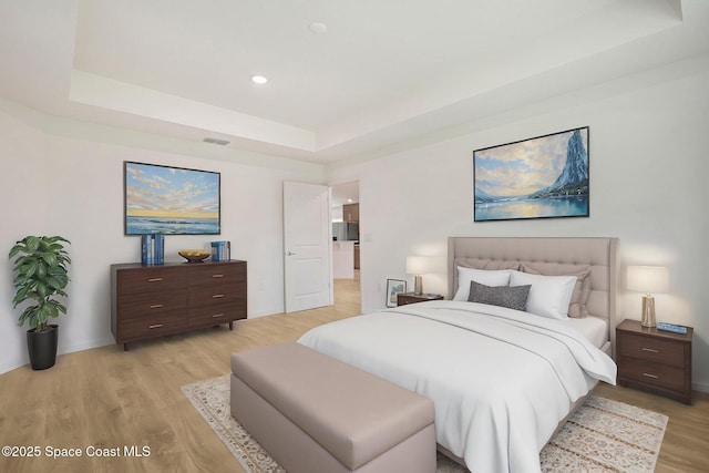 2597 Galiano Ave, Palm Bay, FL 32908 - bedroom featuring light wood finished floors, a tray ceiling, recessed lighting, and baseboards