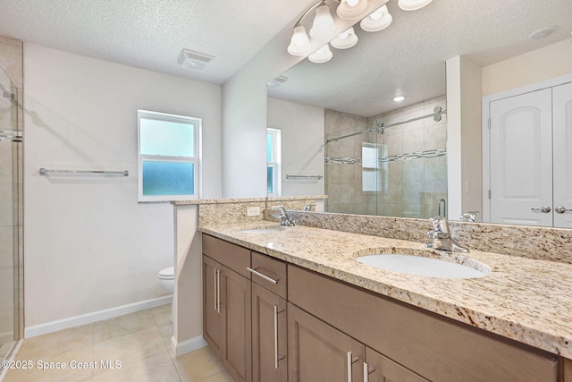 2597 Galiano Ave, Palm Bay, FL 32908 - bathroom with baseboards, a stall shower, double vanity, toilet, and a textured ceiling
