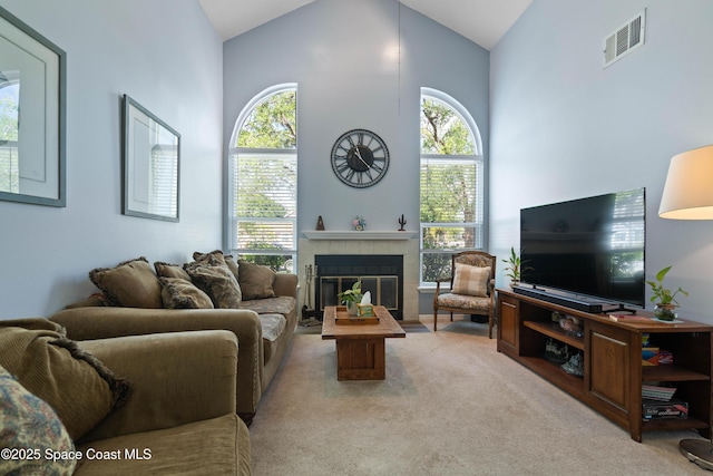 1250 York Cir, Melbourne, FL 32904 - living area featuring carpet flooring, high vaulted ceiling, and a tiled fireplace