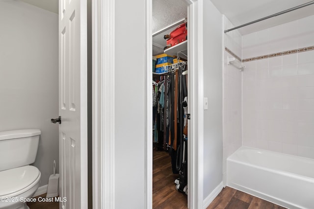 1250 York Cir, Melbourne, FL 32904 - full bathroom with toilet, wood finished floors,  shower combination, a walk in closet, and baseboards