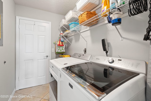 1250 York Cir, Melbourne, FL 32904 - laundry room featuring washer and dryer, light tile patterned floors, and baseboards