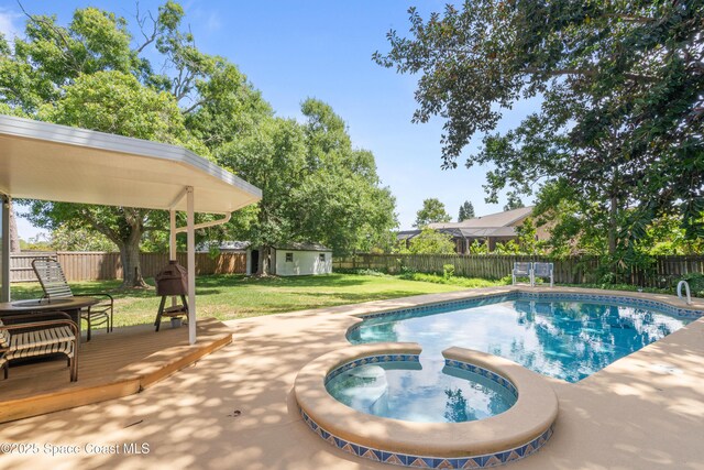 1250 York Cir, Melbourne, FL 32904 - view of swimming pool with an in-ground hot tub, an outbuilding, and a wooden deck