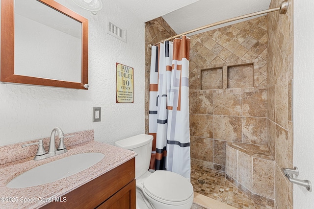 996 S Wickham Rd, West Melbourne, FL 32904 - full bath with toilet, a textured wall, vanity, and tiled shower