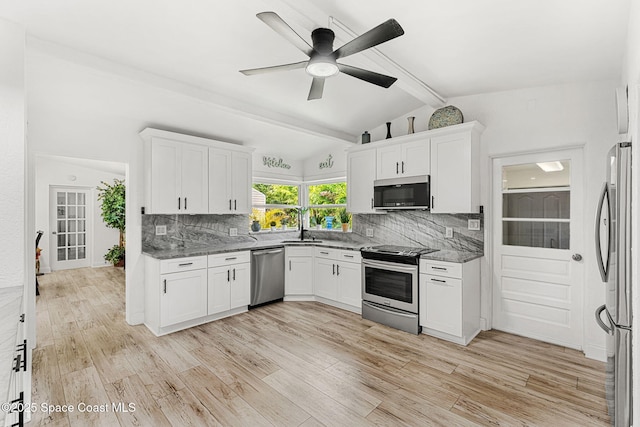 996 S Wickham Rd, West Melbourne, FL 32904 - kitchen featuring stainless steel appliances, tasteful backsplash, light stone counters, and white cabinetry