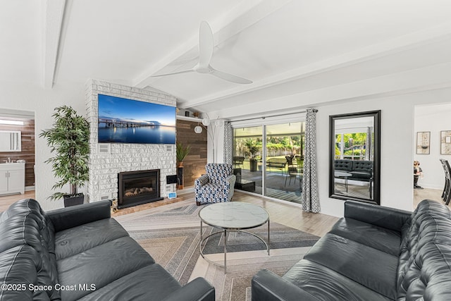 996 S Wickham Rd, West Melbourne, FL 32904 - living area featuring a ceiling fan, light wood-style floors, and a large fireplace