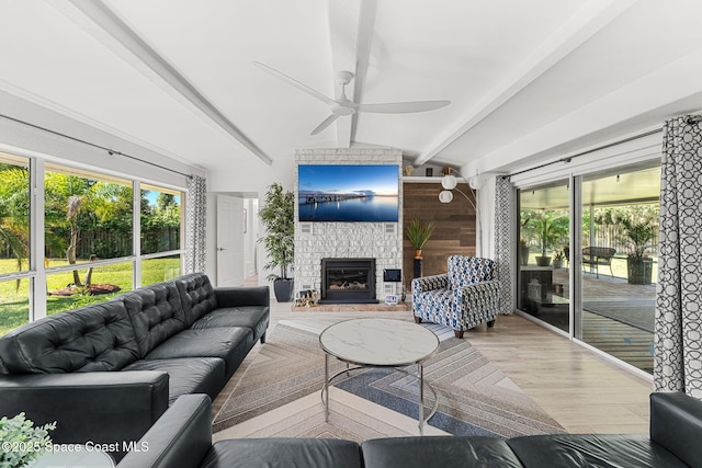 996 S Wickham Rd, West Melbourne, FL 32904 - living area featuring wood finished floors, a ceiling fan, a fireplace, and plenty of natural light