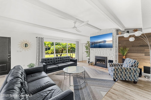 996 S Wickham Rd, West Melbourne, FL 32904 - living area featuring a ceiling fan, beamed ceiling, a fireplace, wood finished floors, and wooden walls