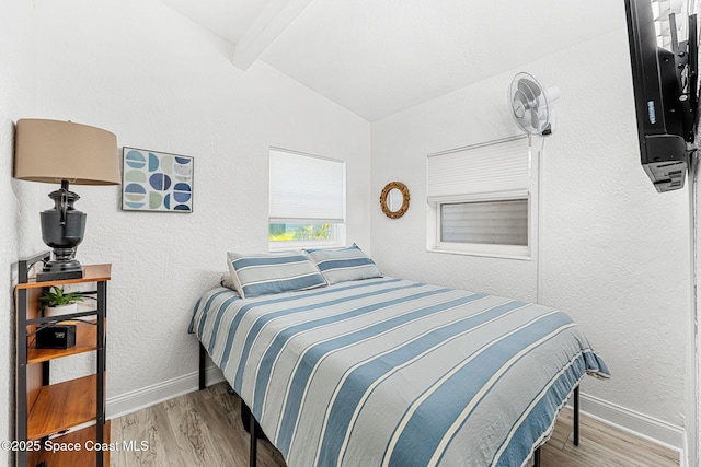 996 S Wickham Rd, West Melbourne, FL 32904 - bedroom with wood finished floors, baseboards, and a textured wall