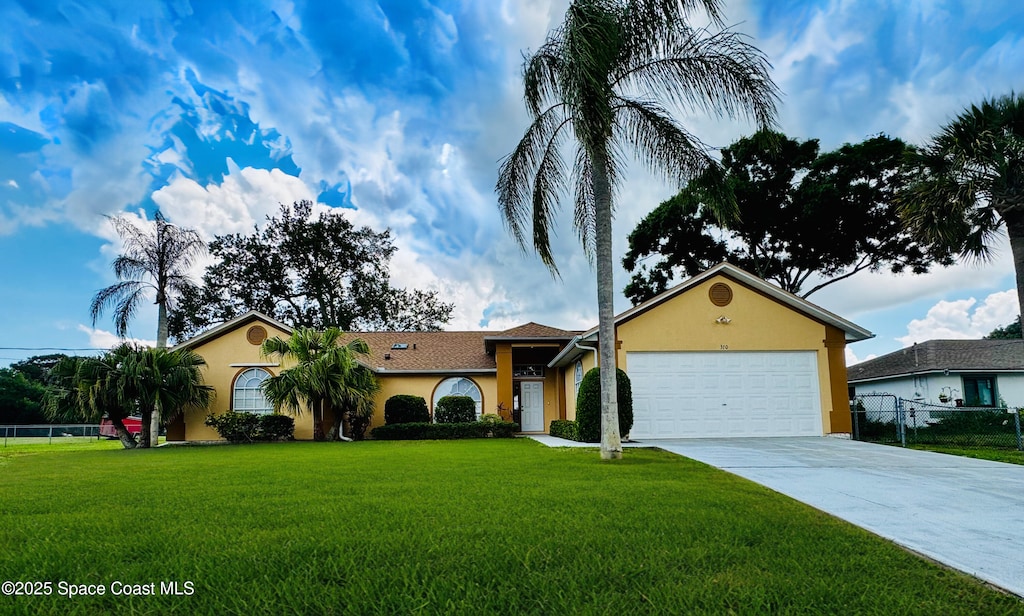 370 Carol Dr NE, Palm Bay, FL 32907 - single story home with stucco siding, a garage, and concrete driveway