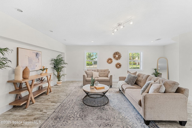 520 Bahama Dr, Indian Harbour Beach, FL 32937 - living room with wood finished floors, a textured ceiling, and baseboards