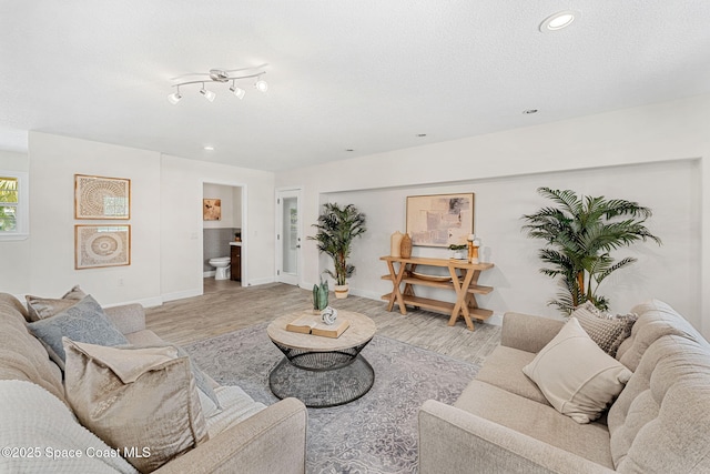 520 Bahama Dr, Indian Harbour Beach, FL 32937 - living room with light wood-style flooring, recessed lighting, baseboards, and a textured ceiling