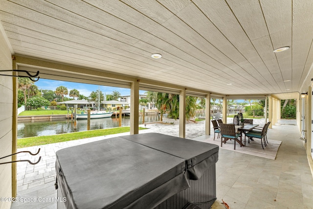520 Bahama Dr, Indian Harbour Beach, FL 32937 - view of patio featuring a hot tub, a water view, and outdoor dining area