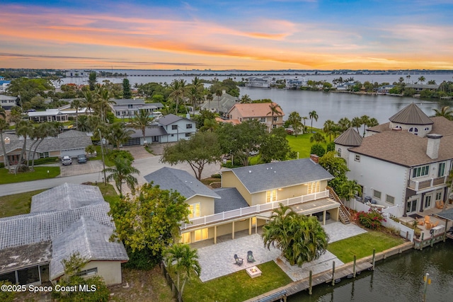 520 Bahama Dr, Indian Harbour Beach, FL 32937 - aerial view at dusk of a water view and a residential view