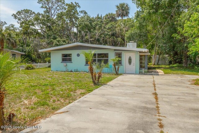 2835 Sunset Rd, Melbourne, FL 32904 - view of front of home with a chimney, driveway, and stucco siding