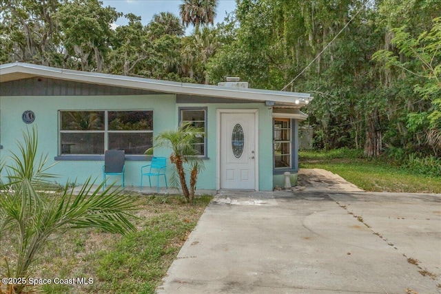 2835 Sunset Rd, Melbourne, FL 32904 - view of front facade with a chimney and stucco siding