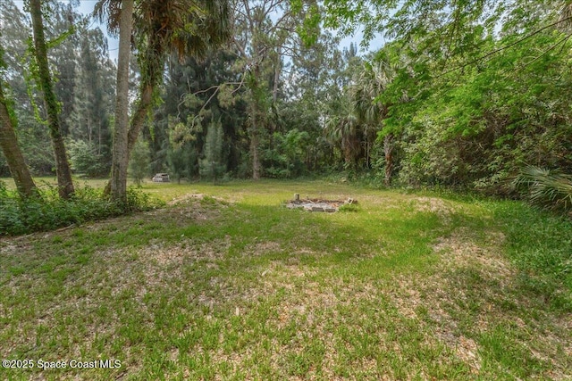 2835 Sunset Rd, Melbourne, FL 32904 - view of grassy yard featuring a wooded view