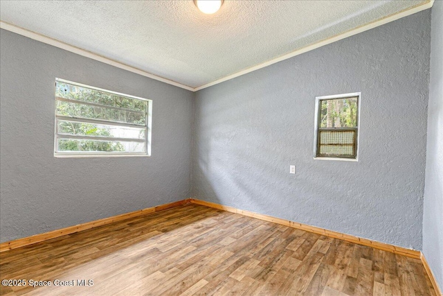 2835 Sunset Rd, Melbourne, FL 32904 - empty room featuring a textured wall, wood finished floors, baseboards, and a textured ceiling