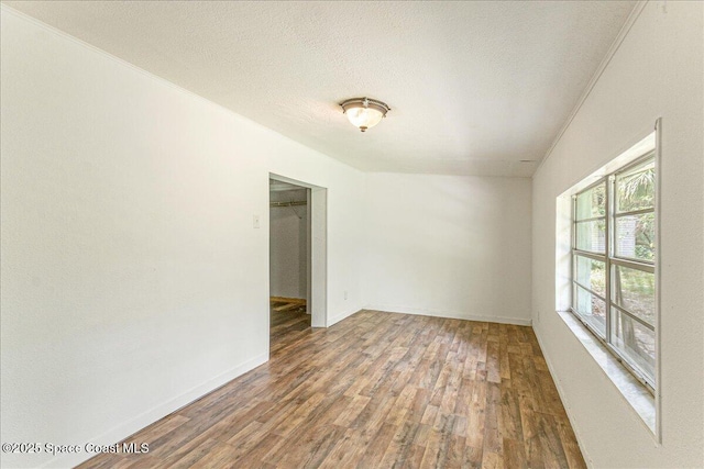 2835 Sunset Rd, Melbourne, FL 32904 - empty room with wood finished floors, a textured ceiling, and baseboards