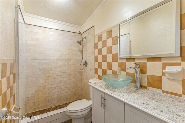 2835 Sunset Rd, Melbourne, FL 32904 - bathroom with tile walls, crown molding, tiled shower, vanity, and toilet