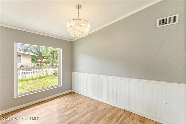 2835 Sunset Rd, Melbourne, FL 32904 - unfurnished room with a chandelier, wood finished floors, and ornamental molding
