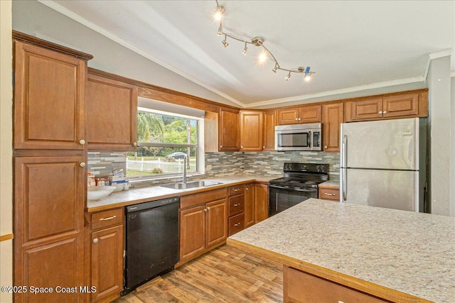 2835 Sunset Rd, Melbourne, FL 32904 - kitchen with black appliances, a sink, light countertops, ornamental molding, and decorative backsplash