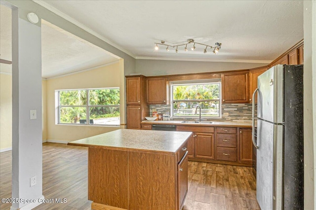 2835 Sunset Rd, Melbourne, FL 32904 - kitchen featuring freestanding refrigerator, a sink, ornamental molding, light wood-style floors, and light countertops