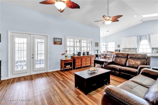 749 Tulip Dr, Sebastian, FL 32958 - living area with ceiling fan, vaulted ceiling, light wood-type flooring, a chandelier, and baseboards